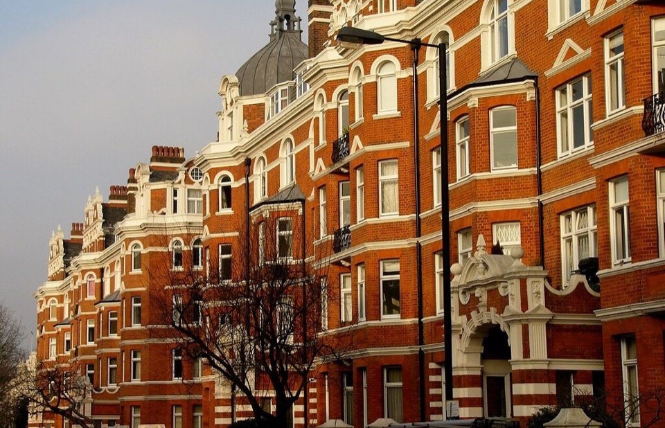 Red brick mansion blocks in west London in afternoon sun